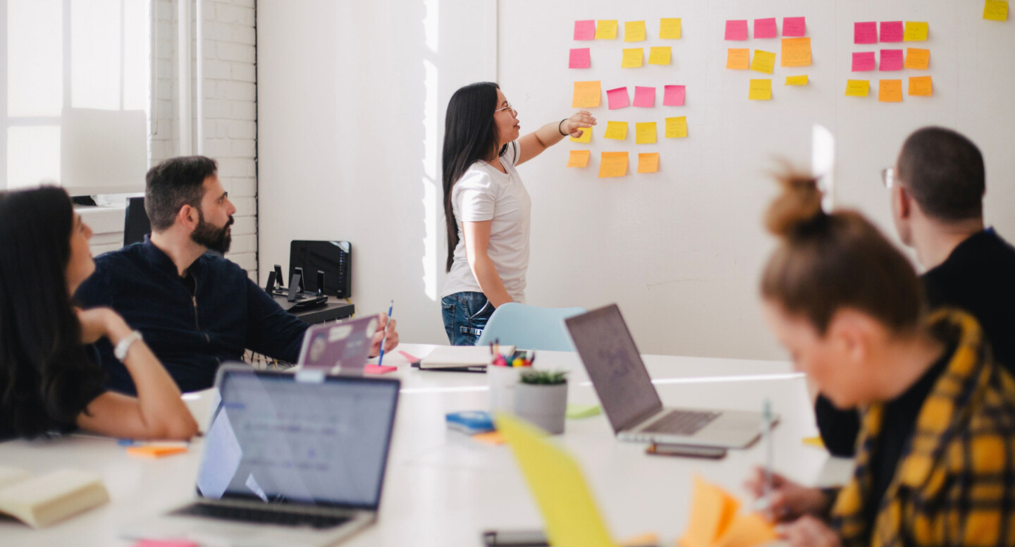 Creative people looking at a whiteboard