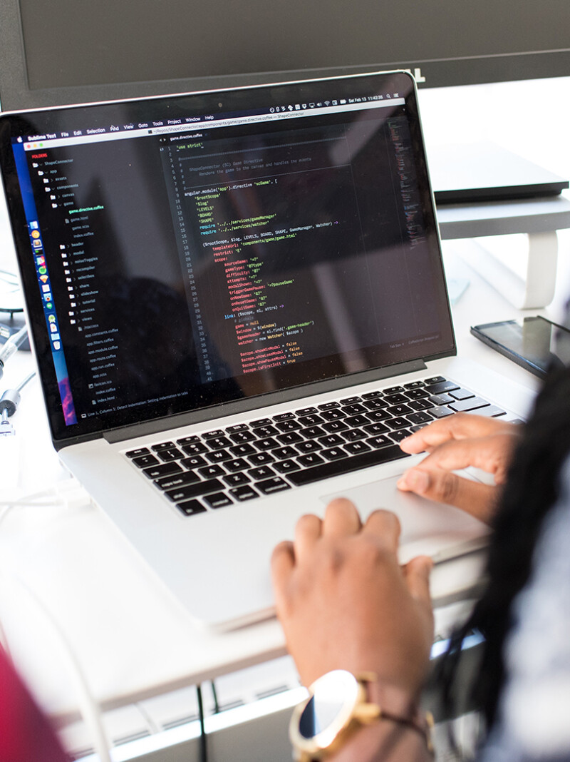 Women coding a website on a laptop